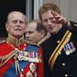 FILE - In this June 14, 2014 file photo, Britain&#39;s Prince Harry talks to Prince Philip, left, as members of the Royal family appear on the balcony of Buckingham Palace, during the Trooping The Colour parade, in central London.  In the TV program ‘Prince Philip: The Royal Family Remembers’ released late Saturday Sept. 18, 2021, members of the royal family spoke admiringly of the late Duke of Edinburgh’s barbecuing skills and Prince Harry described how his grandfather would “never probe” but listen intently about his two tour of duties to Helmand province during the war in Afghanistan. (AP Photo/Lefteris Pitarakis, File)