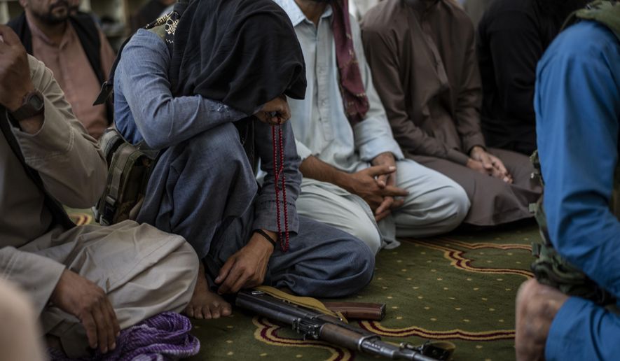 A member of the Taliban prays inside a mosque during Friday prayers in Kabul, Afghanistan, Friday, Sept. 17, 2021. (AP Photo/Bernat Armangue)