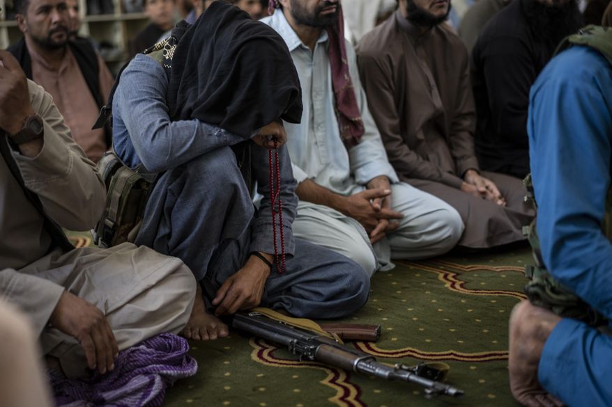 A member of the Taliban prays inside a mosque during Friday prayers in Kabul, Afghanistan, Friday, Sept. 17, 2021. (AP Photo/Bernat Armangue)