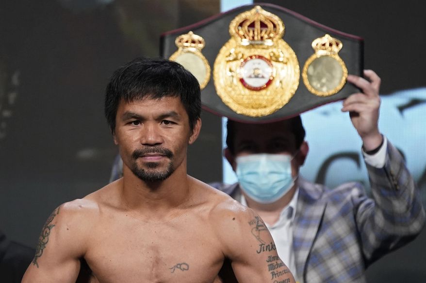 In this Aug. 20, 2021, file photo, Manny Pacquiao, of the Philippines, poses for photographers during a weigh-in in Las Vegas. Philippine boxing icon and senator Pacquiao says he will run for president in the 2022 elections. He accepted the nomination of his PDP-Laban party at its national convention on Sunday, Sept. 19, pledging to honestly serve the Filipino people who he said have been waiting for change in government. (AP Photo/John Locher, File)