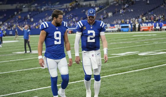 Indianapolis Colts quarterback Carson Wentz (2) walks off the filed with quarterback Jacob Eason (9) following an NFL football game against the Los Angeles Rams, Sunday, Sept. 19, 2021, in Indianapolis. Los Angeles won 27-24. (AP Photo/AJ Mast) **FILE**