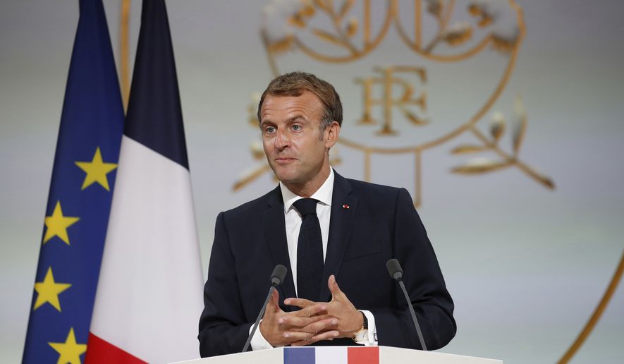 French President Emmanuel Macron delivers a speech during a meeting in memory of the Algerians who fought alongside French colonial forces in Algeria&#x27;s war, known as Harkis, at the Elysee Palace in Paris, Thursday, Sept. 20, 2021. Macron&#x27;s speech is the latest step in his efforts to reconcile France with its dark colonial past, especially in Algeria. (Gonzalo Fuentes/Pool Photo via AP)