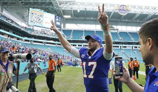 Buffalo Bills quarterback Josh Allen (17) raises his arms at the end of an NFL football game against the Miami Dolphins, Sunday, Sept. 19, 2021, in Miami Gardens, Fla. The Bills defeated the Dolphins 35-0. (AP Photo/Hans Deryk) **FILE**