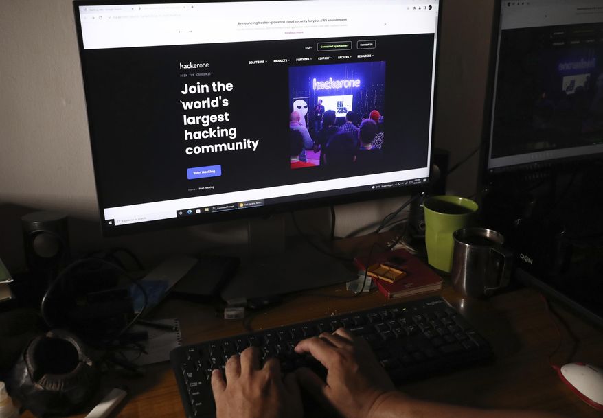 A man visits a hacker community website at a house in Jakarta, Indonesia, Monday, Sept. 20, 2021. Indonesian authorities have found no evidence that the country&#39;s main intelligence service&#39;s computers were compromised, after a U.S.-based private cybersecurity company alerted them of a suspected breach of its internal networks by a Chinese hacking group, an official said. (AP Photo/Tatan Syuflana) **FILE**