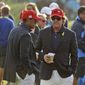 In this Sept. 30, 2018, file photo, Tiger Woods, left, and Phil Mickelson wait for the closing ceremony after Europe won the Ryder Cup on the final day of the 42nd Ryder Cup at Le Golf National in Saint-Quentin-en-Yvelines, outside Paris, France. Woods will be missng from the upcoming Ryder Cup, while Mickelson will serve as a vice-captain on the team. The pandemic-delayed 2020 Ryder Cup returns the United States next week at Whistling Straits along the Wisconsin shores of Lake Michigan.  (AP Photo/Matt Dunha, File) **FILE**