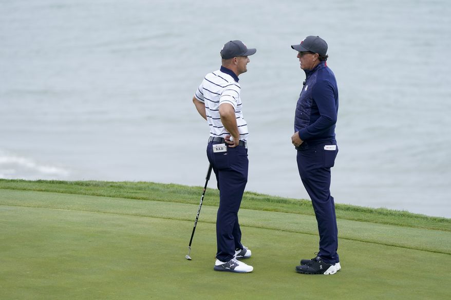 Team USA&#39;s Bryson DeChambeau talks to Phil Mickelson on the third hole during a practice day at the Ryder Cup at the Whistling Straits Golf Course Tuesday, Sept. 21, 2021, in Sheboygan, Wis. (AP Photo/Charlie Neibergall) **FILE**