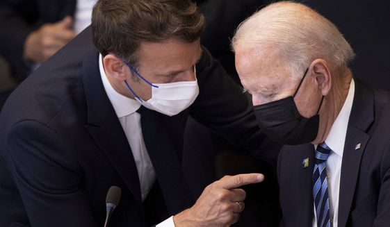 In this June 14, 2021, file photo, U.S. President Joe Biden, right, speaks with French President Emmanuel Macron during a plenary session during a NATO summit at NATO headquarters in Brussels. Macron expects &quot;clarifications and clear commitments&quot; from Biden in a call to be held later on Wednesday to address the submarines&#39; dispute, Macron&#39;s office said. (Brendan Smialowski, Pool via AP, File)