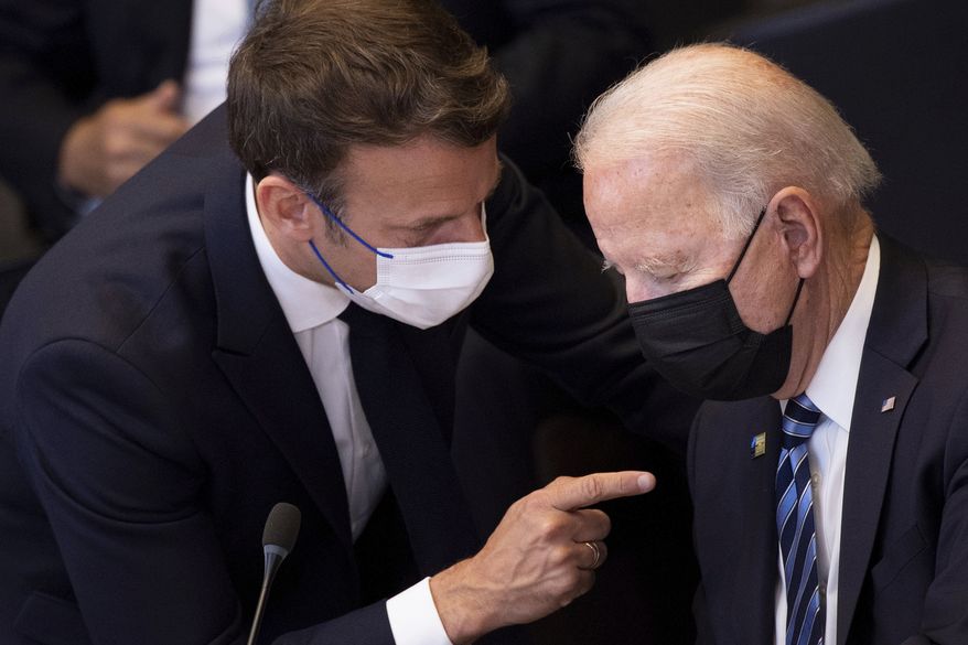In this June 14, 2021, file photo, U.S. President Joe Biden, right, speaks with French President Emmanuel Macron during a plenary session during a NATO summit at NATO headquarters in Brussels. Macron expects &quot;clarifications and clear commitments&quot; from Biden in a call to be held later on Wednesday to address the submarines&#39; dispute, Macron&#39;s office said. (Brendan Smialowski, Pool via AP, File)