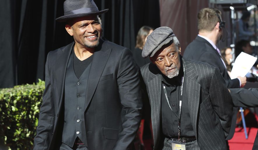 Mario Van Peebles, from left and Melvin Van Peebles arrive at the screening of &amp;quot;The Producers&amp;quot; at the 2018 TCM Classic Film Festival Opening Night at the TCL Chinese Theatre on Thursday, April 26, 2018, in Los Angeles. Melvin Van Peebles, a Broadway playwright, musician and movie director whose work ushered in the “blaxploitation” films of the 1970s, has died at age 89. His family said in a statement that Van Peebles died Tuesday night, Sept. 21, 2021, at his home. (Photo by Willy Sanjuan/Invision/AP, File)