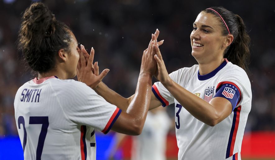 United States forward Alex Morgan, right, high-fives Sophia Smith after scoring a goal during the second half of an international friendly soccer match against Paraguay, Tuesday, Sept. 21, 2021, in Cincinnati. The United States won 8-0. (AP Photo/Aaron Doster) **FILE**