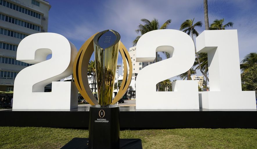 In this Jan. 7, 2021, file photo, the trophy for the College Football Playoff championship NCAA college football game is displayed along Ocean Drive, in Miami Beach, Fla. The College Football Playoff management committee is scheduled to meet Wednesday, Sept. 22, 2021, to discuss the feedback members have received from campuses since a 12-team expansion plan was unveiled in June. (AP Photo/Lynne Sladky, File) **FILE**