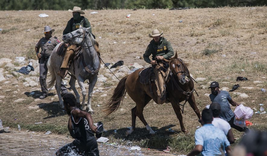 U.S. Customs and Border Protection mounted officers attempt to contain migrants as they cross the Rio Grande from Ciudad Acuna, Mexico, into Del Rio, Texas, Sunday, Sept. 19, 2021. (AP Photo/Felix Marquez) ** FILE **