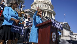 House Speaker Nancy Pelosi, D-Calif., joined at left by Rep. Brenda Lawrence, D-Mich., holds a rally in support of President Joe Biden&#39;s &quot;Build Back Better&quot; for women agenda, at the Capitol in Washington, Friday, Sept. 24, 2021. (AP Photo/J. Scott Applewhite)