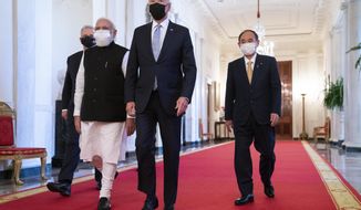 President Joe Biden walks to the Quad summit with, from left, Australian Prime Minister Scott Morrison, Indian Prime Minister Narendra Modi, and Japanese Prime Minister Yoshihide Suga, in the East Room of the White House, Friday, Sept. 24, 2021, in Washington. (AP Photo/Evan Vucci)