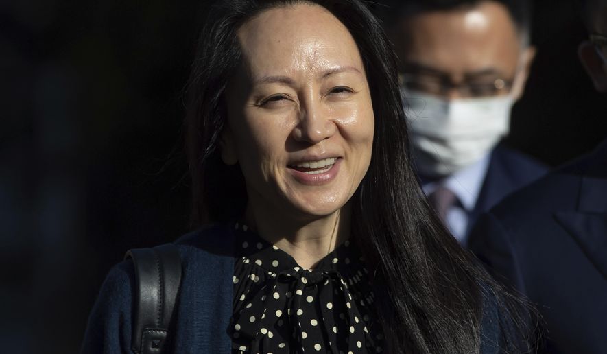 Meng Wanzhou, chief financial officer of Huawei, smiles as she leaves her home in Vancouver on Friday, Sept. 24, 2021.  (Darryl Dyck/The Canadian Press via AP)