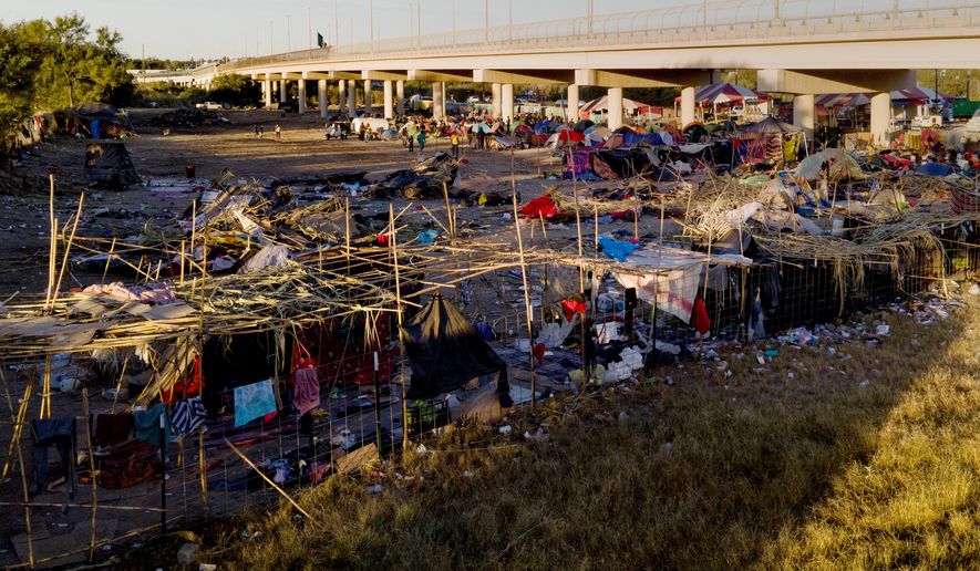 Migrants, many from Haiti, are seen in an encampment near the Del Rio International Bridge, Friday, Sept. 24, 2021, in Del Rio, Texas. (AP Photo/Julio Cortez)