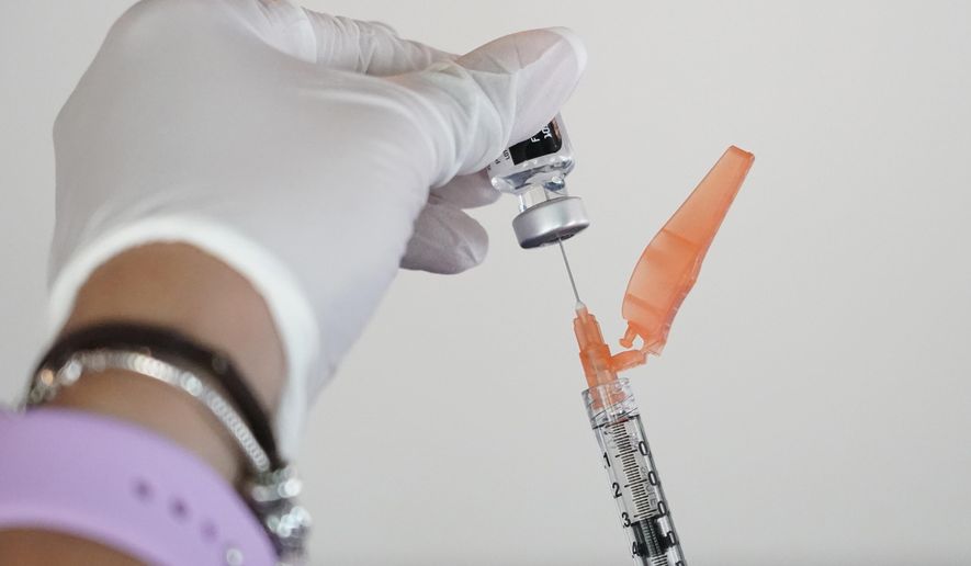 In this Tuesday, Sept. 21, 2021 file photo, a nurse loads a syringe with the Pfizer COVID-19 vaccine in Jackson, Miss. Millions of Americans are now eligible to receive a Pfizer booster shot to help increase their protection against the worst effects of the coronavirus. (AP Photo/Rogelio V. Solis)