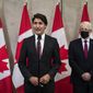 Prime Minister Justin Trudeau stands with Minister of Foreign Affairs Marc Garneau to announce that Canadians Michael Spavor and Michael Kovrig have been released from detention in China, on Parliament Hill in Ottawa, on Friday, Sept. 24, 2021. (Justin Tang/The Canadian Press via AP)