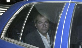 In this Nov. 18, 2003, file photo, John Hinckley Jr. arrives at U.S. District Court in Washington. Lawyers for Hinckley, the man who tried to assassinate President Ronald Reagan, are scheduled to argue in court Monday, Sept. 27, 2021, that the 66-year-old should be freed from restrictions placed on him after he moved out of a Washington hospital in 2016. (AP Photo/Evan Vucci, File)
