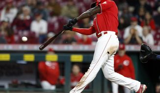 Cincinnati Reds&#39; Aristides Aquino hits a RBI single to win the game against Washington Nationals pitcher Mason Thompson during the 11th inning of a baseball game in Cincinnati, Friday, Sept. 24, 2021. The Reds won 8-7. (AP Photo/Paul Vernon)