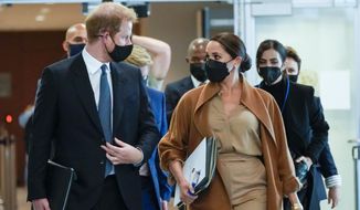 Prince Harry and Meghan, the Duke and Duchess of Sussex are escorted as they leave the United Nations headquarters after a visit during 76th session of the United Nations General Assembly, Saturday, Sept. 25, 2021. (AP Photo/Mary Altaffer)