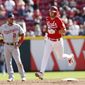 Cincinnati Reds&#39; Kyle Farmer, right, rounds the bases after his grand slam home run against the Washington Nationals during the sixth inning of a baseball game Sunday, Sept. 26, 2021, in Cincinnati. (AP Photo/Jay LaPrete)