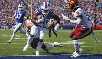 Buffalo Bills running back Zack Moss (20) runs past Washington Football Team&#39;s Cole Holcomb (55) for a touchdown as quarterback Josh Allen (17) watches during the first half of an NFL football game Sunday, Sept. 26, 2021, in Orchard Park, N.Y. (AP Photo/Jeffrey T. Barnes)