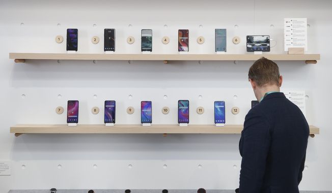 In this Jan. 8, 2020, file photo, the Google exhibit building shows off a variety of devices with Google Assistant, including Android smartphones and Wear OS smartwatches during the CES tech show in Las Vegas, Nevada, USA. (AP Photo/Ross D. Franklin, File)