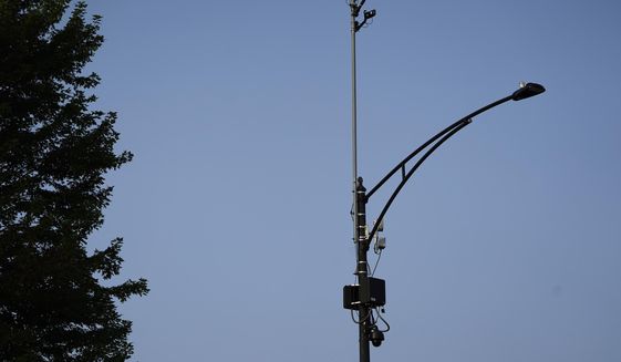 In this Aug. 10, 2021, file photo, ShotSpotter equipment overlooks the intersection of South Stony Island Avenue and East 63rd Street in Chicago. Critics decry the multimillion-dollar system not only in terms of its expense and inaccuracy, but for what they say is a pattern of bias in deploying police resources disproportionately into minority communities.  (AP Photo/Charles Rex Arbogast, File)  **FILE**