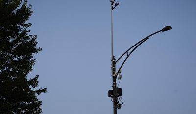 In this Aug. 10, 2021, file photo, ShotSpotter equipment overlooks the intersection of South Stony Island Avenue and East 63rd Street in Chicago. Critics decry the multimillion-dollar system not only in terms of its expense and inaccuracy, but for what they say is a pattern of bias in deploying police resources disproportionately into minority communities.  (AP Photo/Charles Rex Arbogast, File)  **FILE**