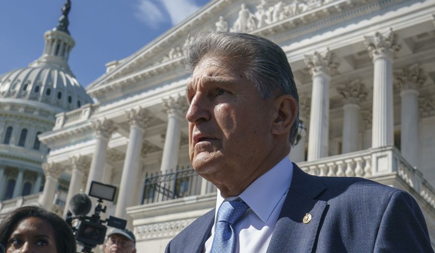 Sen. Joe Manchin, D-W.Va., a centrist Democrat vital to the fate of President Joe Biden&#39;s $3.5 trillion domestic agenda, is surrounded by reporters outside the Capitol in Washington, Wednesday, Sept. 29, 2021. Manchin and other senators were boarding a bus to attend a memorial service for the late Susan Bayh, the wife of former Senator Evan Bayh of Indiana, who died earlier in the year. (AP Photo/J. Scott Applewhite)