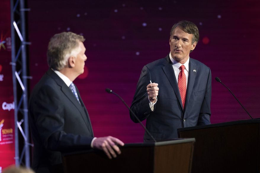 Virginia Democratic gubernatorial candidate and former Gov. Terry McAuliffe, left, and Republican challenger, Glenn Youngkin, participate in their debate at Northern Virginia Community College, in Alexandria, Va., Tuesday, Sept. 28, 2021. Mr. Youngkin is running a new campaign ad based on a line Mr. McAuliffe said in the debate suggesting parents should not control public-school curriculum decisions. (AP Photo/Cliff Owen)