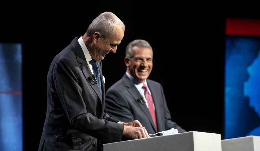 Incumbent Gov. Phil Murphy, D-N.J., left, and Republican challenger Jack Ciattarelli laugh on stage during a gubernatorial debate at New Jersey Performing Arts Center, Tuesday, Sept. 28, 2021, in Newark, N.J. (Amy Newman/The Record via AP) ** FILE **
