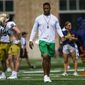 In this Aug. 12, 2021, file photo, Notre Dame defensive coordinator Marcus Freeman watches during NCAA college football practice in South Bend, Ind. As Notre Dame linebacker Drew White ran into the Wisconsin end zone for the second Irish pick-six in two minutes, the identity of defensive coordinator Marcus Freeman’s unit had never been clearer.  On full display at Soldier Field on Saturday was the lauded defense that has garnered so much praise from Freeman’s players since he was hired in January. (Michael Caterina/South Bend Tribune via AP) **FILE**