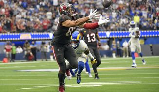 Tampa Bay Buccaneers tight end Rob Gronkowski reaches but cannot make a catch during the first half of an NFL football game against the Los Angeles Rams Sunday, Sept. 26, 2021, in Inglewood, Calif. (AP Photo/Kevork Djansezian)