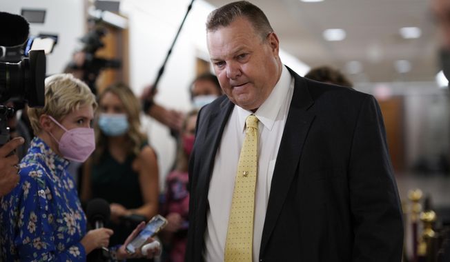 Sen. Jon Tester, D-Mont., stops for reporters asking about the fate of President Joe Biden&#x27;s plan for social and environmental spending, at the Capitol in Washington. (AP Photo/J. Scott Applewhite)