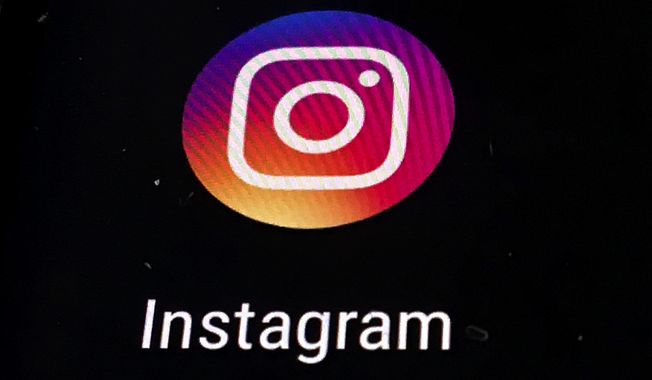 In this Nov. 29, 2018, file photo, the Instagram app logo is displayed on a mobile screen in Los Angeles. Political adversaries in Congress are united in outrage against Facebook for privately compiling information that its Instagram photo-sharing service appeared to grievously harm some teens, especially girls, while publicly downplaying the popular platform’s negative impact. Facebook’s head of global safety, Antigone Davis, has been summoned to testify for a hearing Thursday, Sept. 30, 2021, by a Senate panel. (AP Photo/Damian Dovarganes, File)