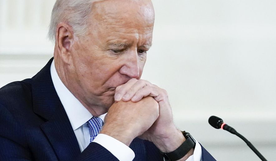 In this Sept. 24, 2021 photo, President Joe Biden listens during the Quad summit in the East Room of the White House. President Joe Biden&#x27;s popularity has slumped — with half of Americans now approving and half disapproving of his leadership. That&#x27;s according to a new poll by The Associated Press-NORC Center for Public Affairs Research. (AP Photo/Evan Vucci)