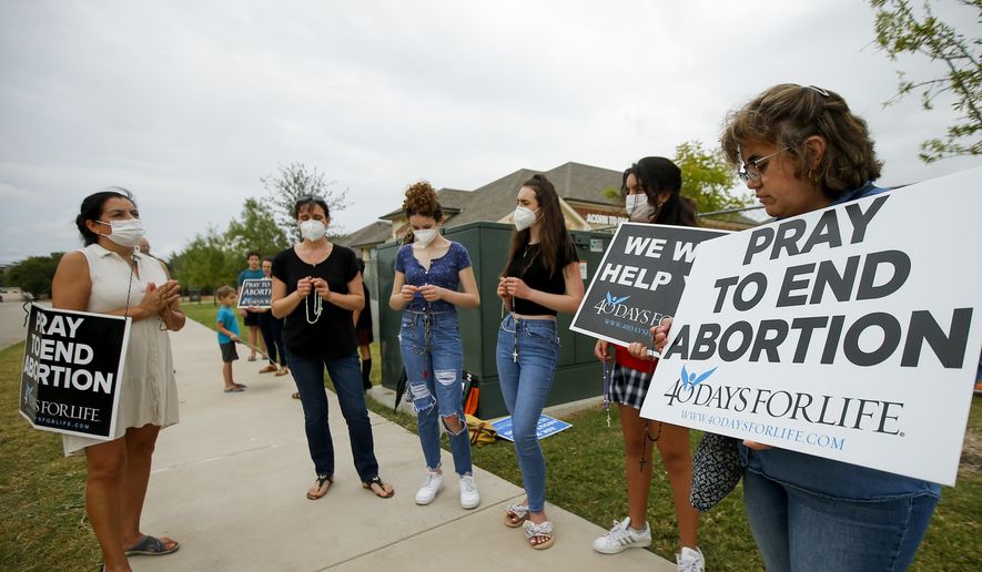 Anti-abortion demonstrators pray and protest outside of a Whole Women&#39;s Health of North Texas, Friday, Oct. 1, 2021, in McKinney, Texas. A federal judge did not say when he would rule following a nearly three-hour hearing in Austin during which abortion providers sought to block the nation&#39;s most restrictive abortion law, which has banned most abortions in Texas since early September. (AP Photo/Brandon Wade)