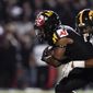 Maryland running back Isaiah Jacobs, left, rushes the ball as Iowa defensive back Kaevon Merriweather tries to bring him down during the second half of an NCAA college football game, Friday, Oct. 1, 2021, in College Park, Md. (AP Photo/Julio Cortez)