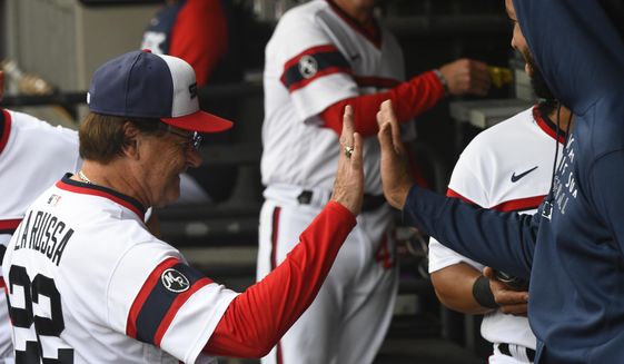 CORRECTS TO OCT. NOT AUG - Chicago White Sox manager Tony La Russa, left, high fives first baseman Jose Abreu before a baseball game against the Detroit Tigers, Sunday, Oct. 3, 2021, in Chicago. (AP Photo/Matt Marton) **FILE**