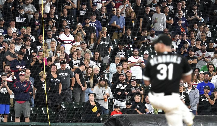 Fans stand as they watch Chicago White Sox relief pitcher Liam Hendriks work during the ninth inning of a baseball game against the Detroit Tigers in Chicago, Saturday, Oct. 2, 2021. (AP Photo/Nam Y. Huh) **FILE**