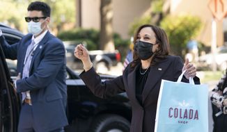 Vice President Kamala Harris reacts to people waving as she exits The Colada Shop, a Latina owned coffee shop, Monday, Oct. 4, 2021, in Washington. (AP Photo/Jacquelyn Martin)