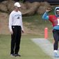 In this May 22, 2019, file photo, then-Carolina Panthers&#39; Cam Newton (1) stretches on the sidelines as then-head trainer Ryan Vermillion watches during the NFL football team&#39;s practice in Charlotte, N.C. The Washington Football Team has placed head athletic trainer Ryan Vermillion on administrative leave for what a spokesman calls an ongoing criminal investigation unrelated to the club. Vermillion is in his second season with coach Ron Rivera in Washington after 18 seasons working for the Carolina Panthers. (AP Photo/Chuck Burton, File)