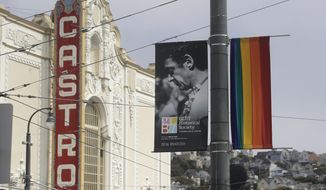 A photo of Harvey Milk, the murdered California politician and gay rights icon, is displayed on a sign for the GLBT Historical Society next to a rainbow flag in front of the Castro Theatre in San Francisco, Saturday, June 27, 2020. (AP Photo/Jeff Chiu) **FILE**