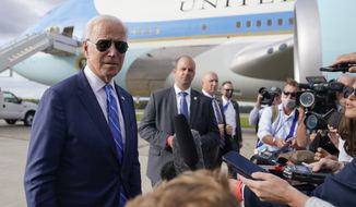 President Joe Biden speaks to members of the media before boarding Air Force One at Capital Region International Airport, Tuesday, Oct. 5, 2021, in Lansing, Mich. (AP Photo/Evan Vucci)