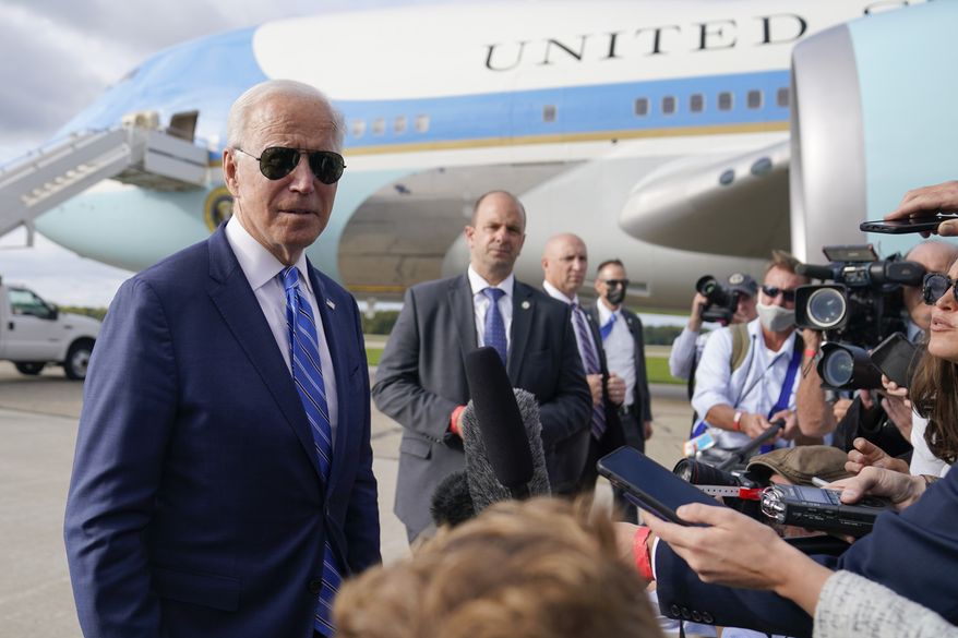 President Joe Biden speaks to members of the media before boarding Air Force One at Capital Region International Airport, Tuesday, Oct. 5, 2021, in Lansing, Mich. (AP Photo/Evan Vucci)