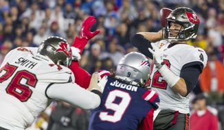 Tampa Bay Buccaneers quarterback Tom Brady (12) prepares to make a pass while pressured by New England Patriots outside linebacker Matt Judon (9) during the first half of an NFL football game, Sunday, Oct. 3, 2021, in Foxborough, Mass. (AP Photo/Greg M. Cooper)
