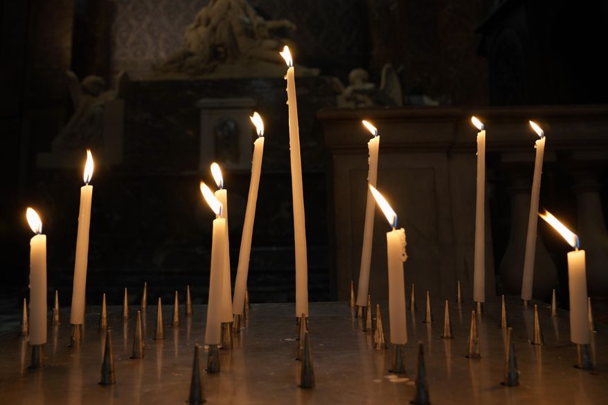 Candles are lighten in a Catholic Church in central Paris, Tuesday, Oct. 5, 2021. The head of France&#39;s Catholic bishops conference is asking forgiveness from the estimated 330,000 victims of child sex abuse by the church found in a groundbreaking report. The report was released Tuesday after extensive research in France&#39;s first major reckoning with the issue. (AP Photo/Francois Mori)