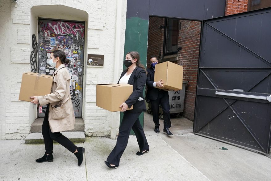 Federal agents remove boxes of evidence from the building that houses the Sergeants Benevolent Association offices, Tuesday, Oct. 5, 2021, in New York. Federal agents raided the offices of the New York City police union whose leader has clashed with city officials over his incendiary tweets and hard-line tactics. They also raided the Long Island home of Sergeants Benevolent Association President Ed Mullins. (AP Photo/Mary Altaffer)